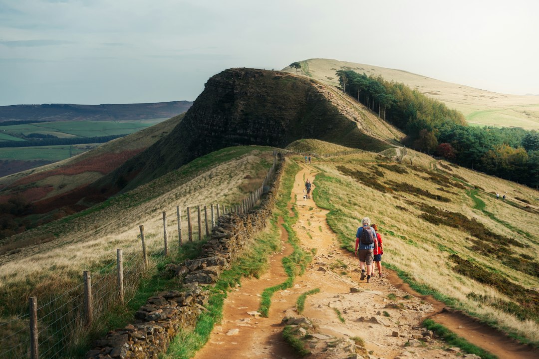 Friends walking together along a Peak District trail on a weekend group getaway