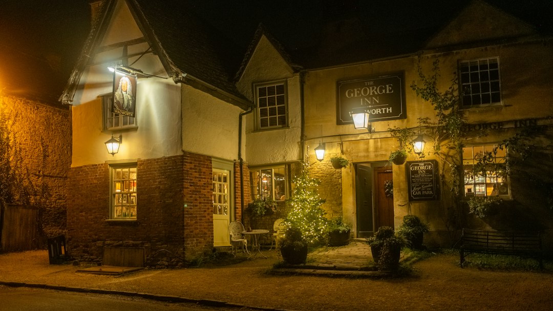 A quaint village pub lit up with warm lighting on a cold Derbyshire winter evening