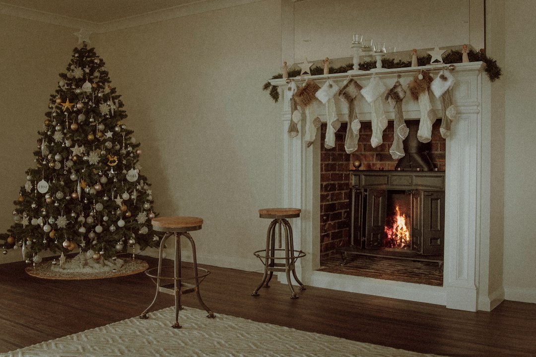 Cosy cottage living room with Christmas tree by the fireplace, a Peak District holiday cottage ready for a family Christmas