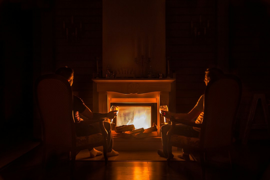 Couple relaxing by a cosy fireplace during a quiet New Year retreat in the Peak District