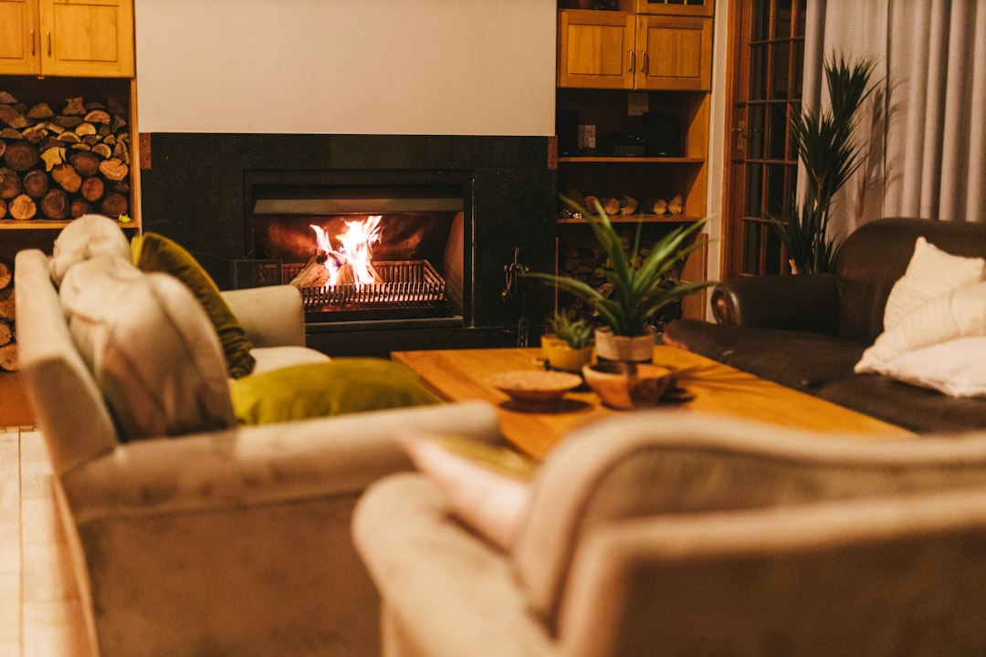 Family gathered in a cosy living room with a fireplace, playing games together during a Peak District holiday cottage stay